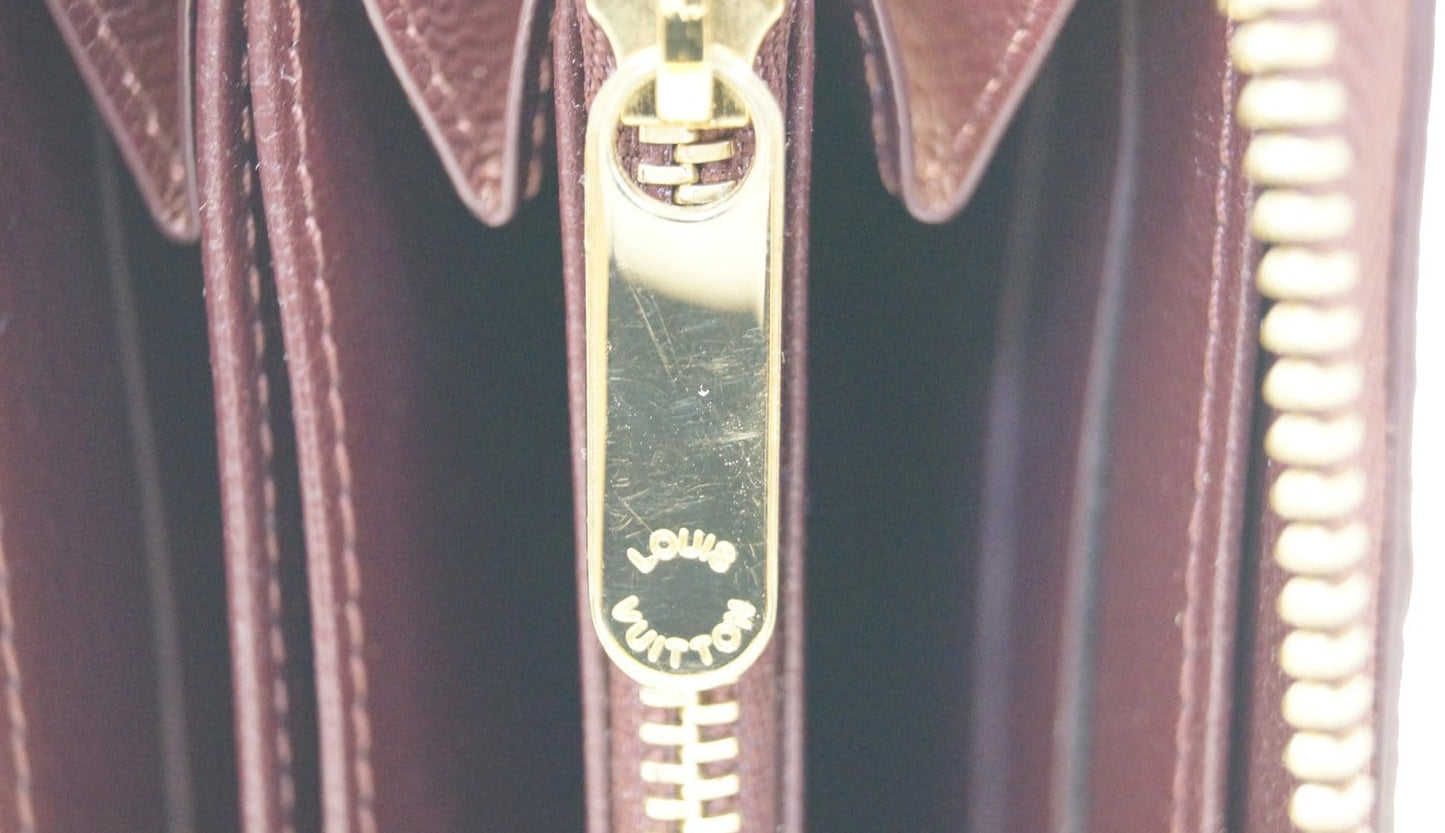 LOUIS VUITTON Burgundy Ostrich Leather Zippy Wallet - Sale