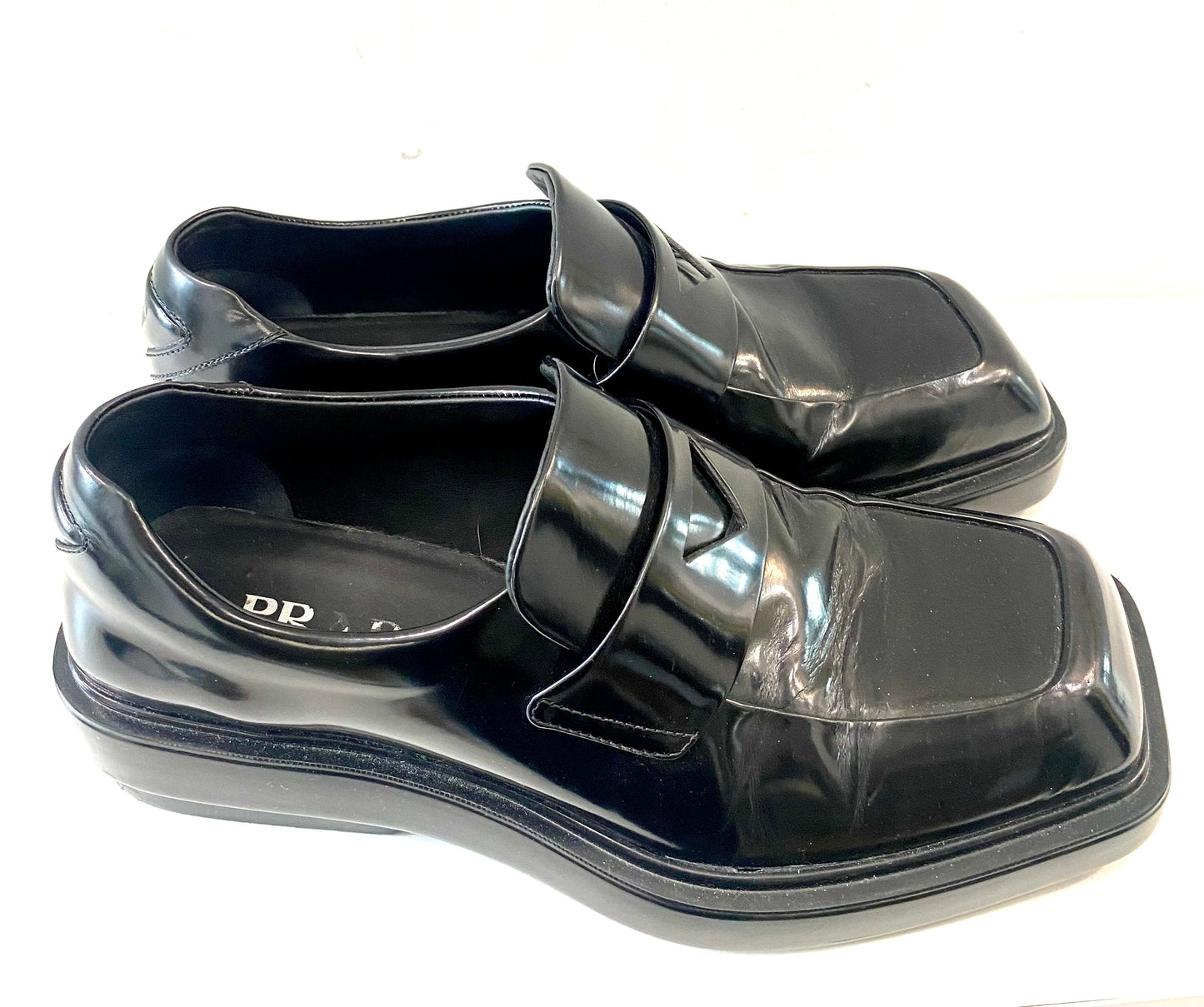 PRADA TRIANGLE LOGO PATCH SLIP-ON LOAFERS